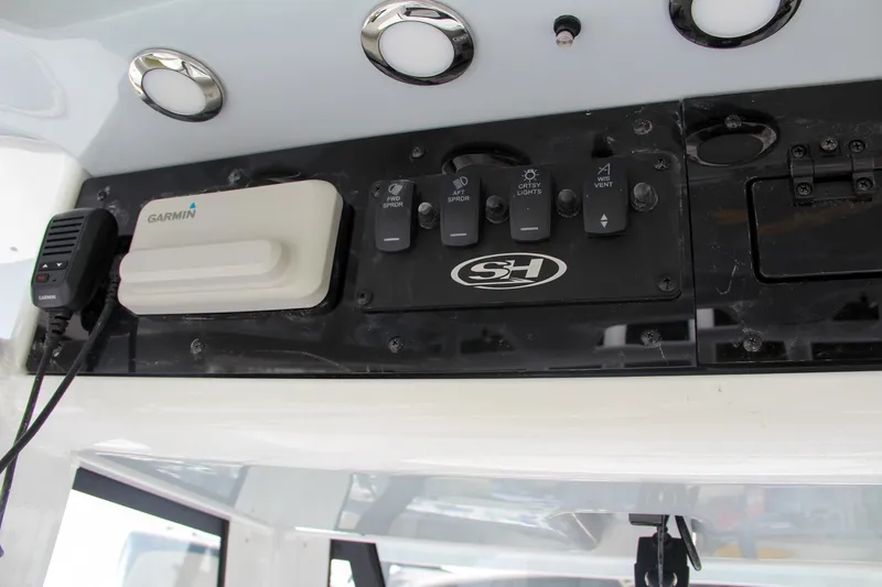 Slide: The Image of 2024 Sea Hunt Ultra 239 SE control panel with Garmin device and switches. - 46