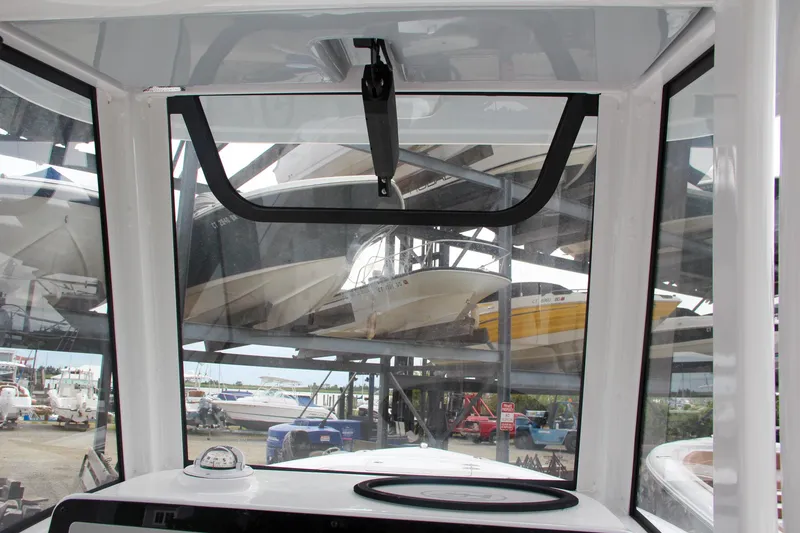 Slide: The Image of 2024 Sea Hunt Ultra 239 SE boat interior view with marina background. - 47