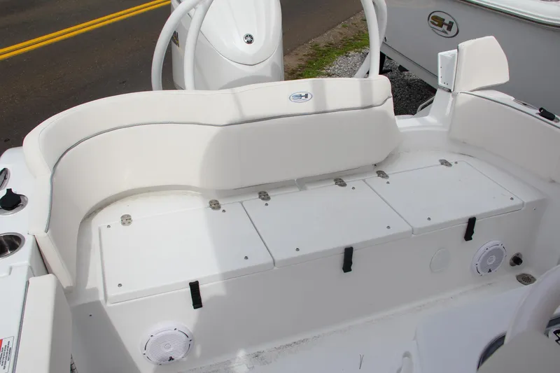 Slide: The Image of 2024 Sea Hunt Ultra 239 SE boat with white seating and storage compartments. - 7