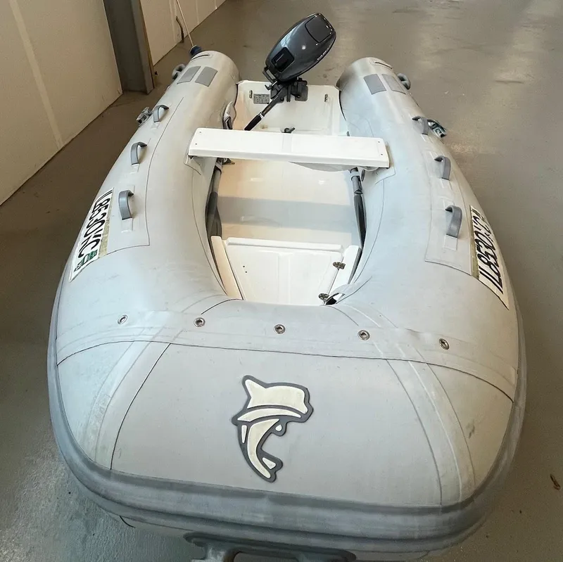 Slide: The Image of Inflatable Caribe c-10X boat, 2007 model, with outboard motor in a garage. - 2