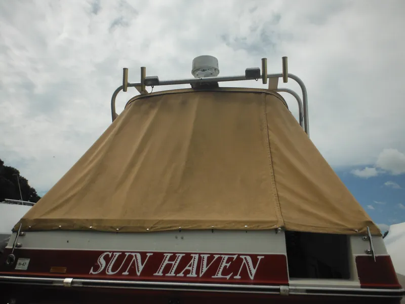 Slide: The Image of 1988 Sea Ray 268 Sundancer boat with tan cover and Sun Haven name. - 10