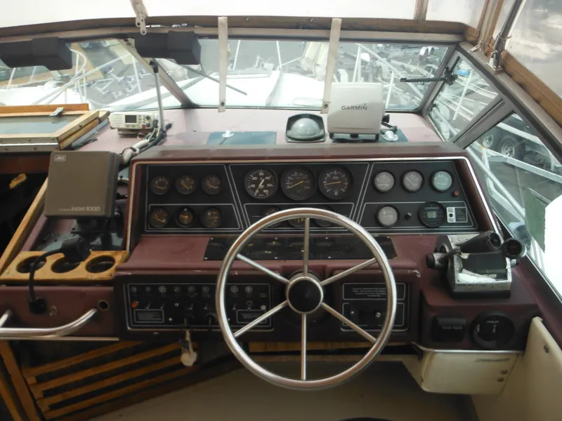 Slide: The Image of 1988 Sea Ray 268 Sundancer boat dashboard with steering wheel and navigation instruments. - 18