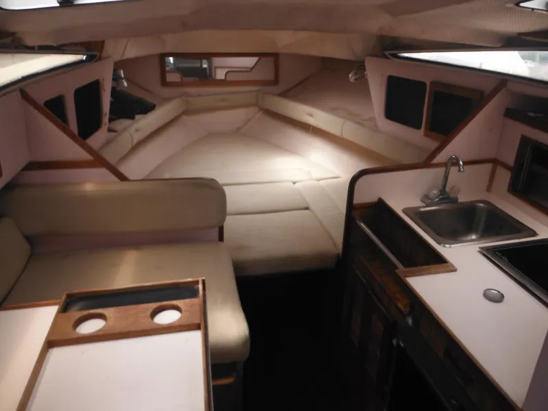 Slide: The Image of Interior of 1988 Sea Ray 268 Sundancer boat with seating, sink, and sleeping area. - 23