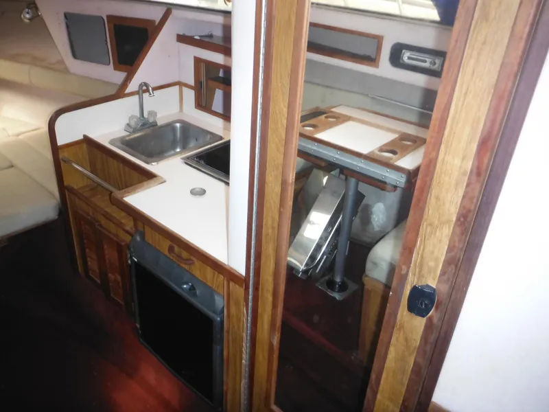 Slide: The Image of 1988 Sea Ray 268 Sundancer interior kitchen and dining area. - 24