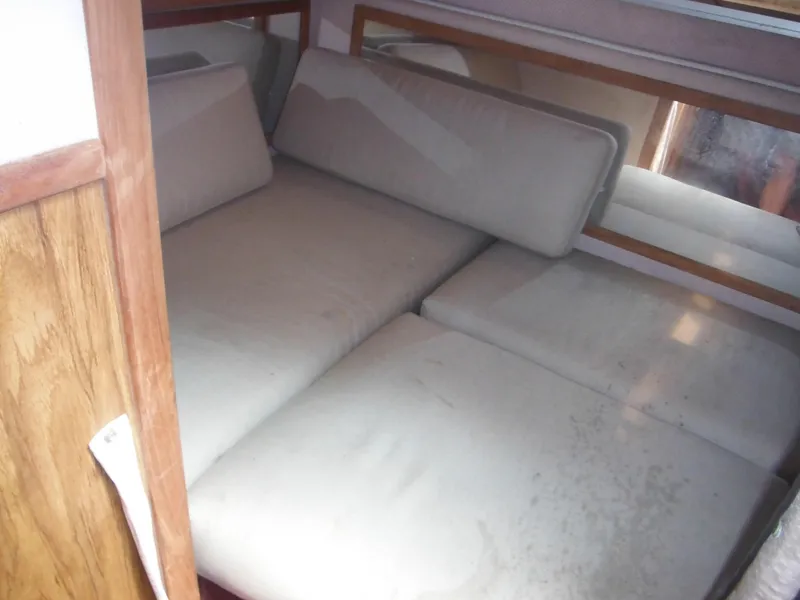 Slide: The Image of Interior cabin bed of 1988 Sea Ray 268 Sundancer boat with beige cushions. - 28