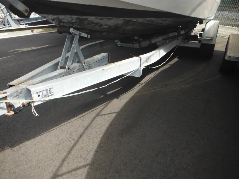 Slide: The Image of 1988 Sea Ray 268 Sundancer on a boat trailer, close-up view of the hull and trailer. - 3