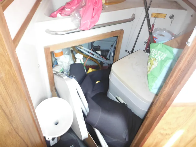 Slide: The Image of Cluttered storage area inside a 1988 Sea Ray 268 Sundancer boat. - 30