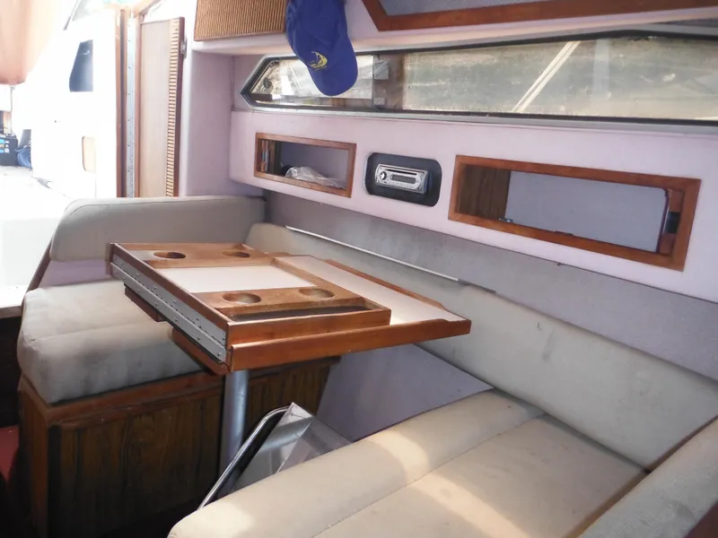 Slide: The Image of Interior of 1988 Sea Ray 268 Sundancer with dining area and wooden table. - 33