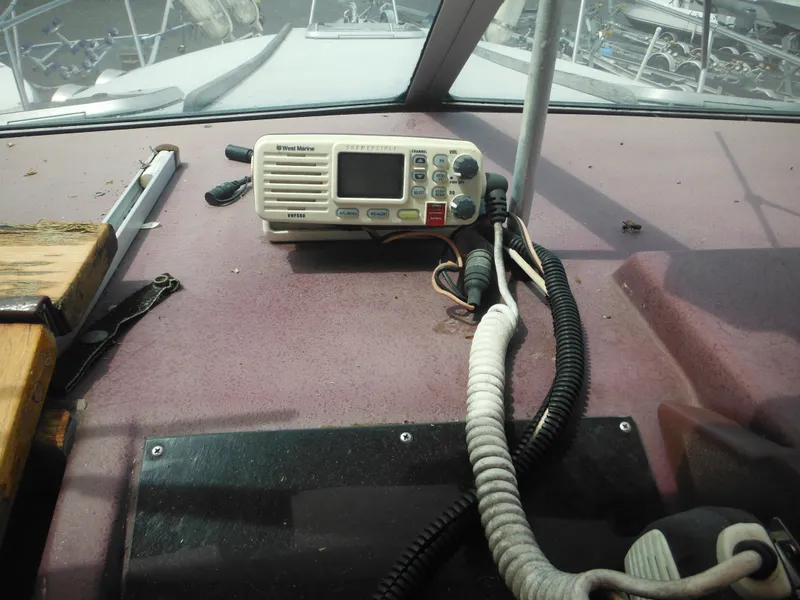 Slide: The Image of 1988 Sea Ray 268 Sundancer dashboard with marine radio and controls. - 40