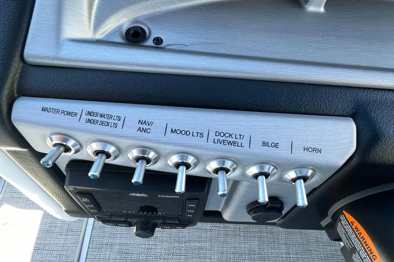 Slide: The Image of Control panel of a 2023 Berkshire 24 UL CTS boat with labeled switches. - 16