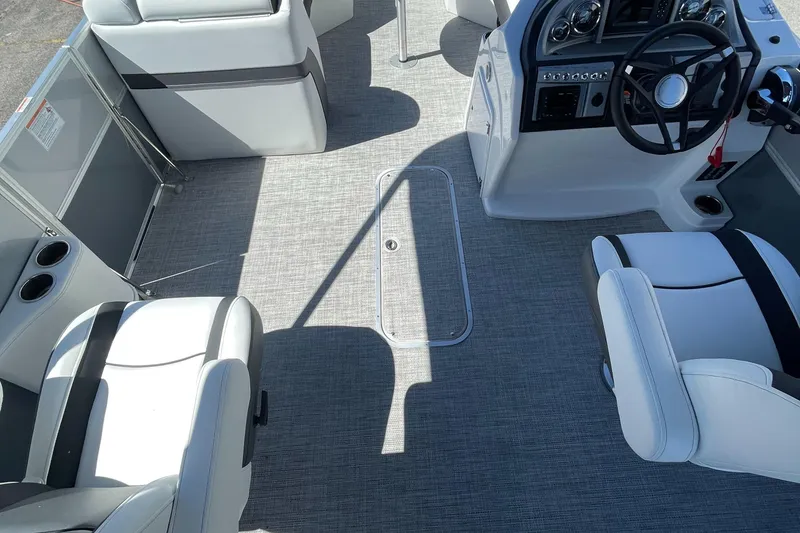 Slide: The Image of 2023 Berkshire 24 UL CTS boat interior with steering console and seating. - 19