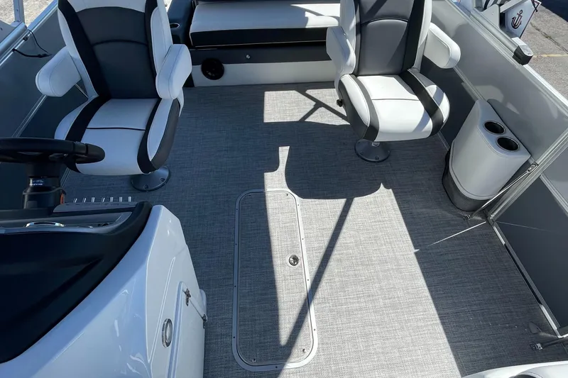 Slide: The Image of 2023 Berkshire 24 UL CTS boat interior with seating and steering console. - 21