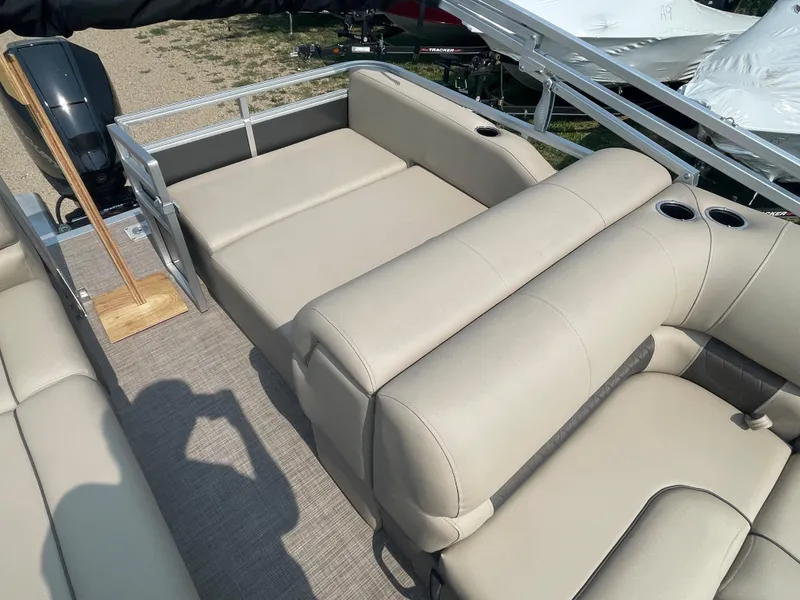 Slide: The Image of 2024 Sun Tracker Party Barge 22 RF XP3 interior with beige seating and cup holders. - 12