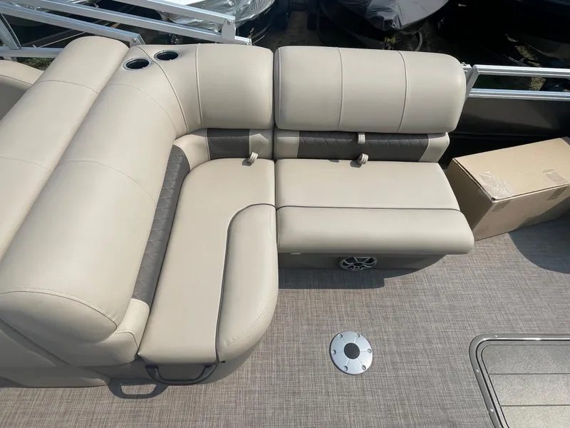 Slide: The Image of 2024 Sun Tracker Party Barge 22 RF XP3, beige seating area with cup holders. - 13