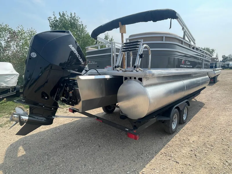 Slide: The Image of 2024 Sun Tracker Party Barge 22 RF XP3 pontoon boat on a trailer. - 2