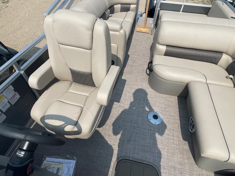 Slide: The Image of 2024 Sun Tracker Party Barge 22 RF XP3 interior with beige seating and steering wheel. - 7
