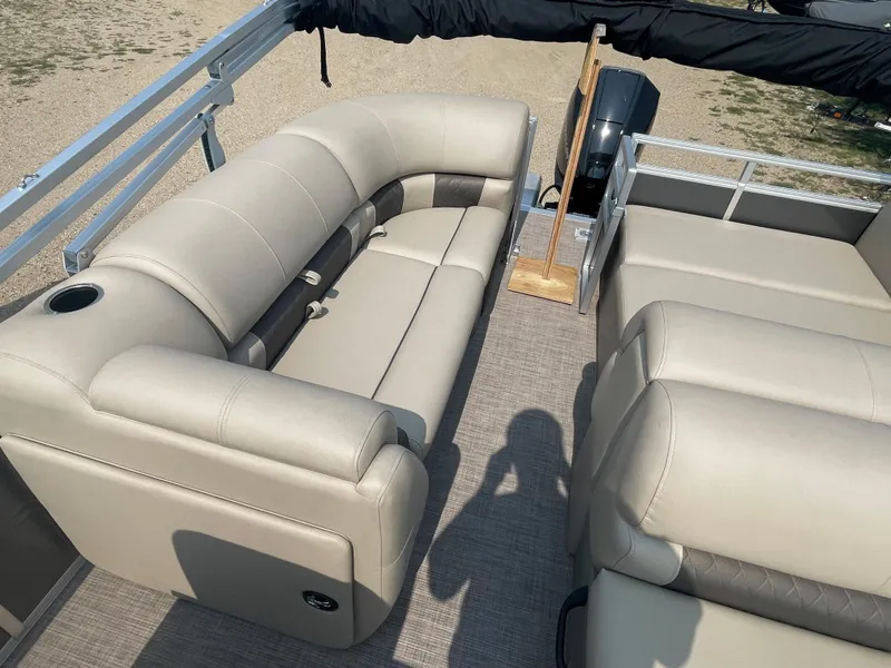 Slide: The Image of 2024 Sun Tracker Party Barge 22 RF XP3 interior with beige seating and spacious layout. - 8