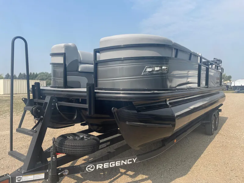 Slide: The Image of 2024 Regency 250 DL3 pontoon boat on a trailer. - 0