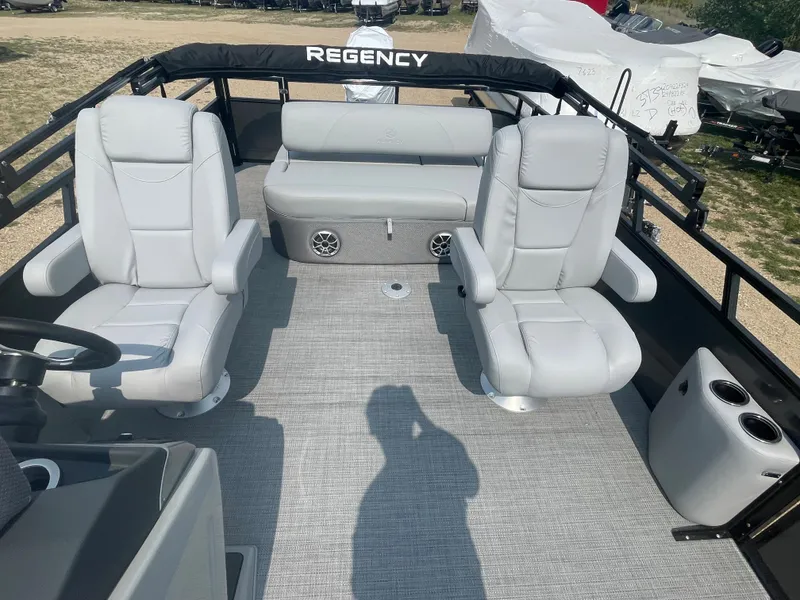 Slide: The Image of 2024 Regency 250 DL3 pontoon boat interior with plush seating and modern design. - 12