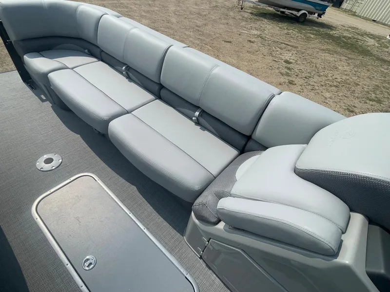 Slide: The Image of 2024 Regency 250 DL3 pontoon boat with spacious, cushioned seating. - 18