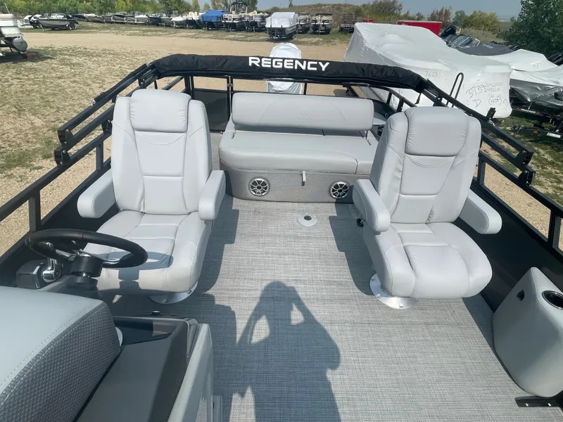 Slide: The Image of 2024 Regency 250 DL3 pontoon boat with spacious seating and modern design. - 21