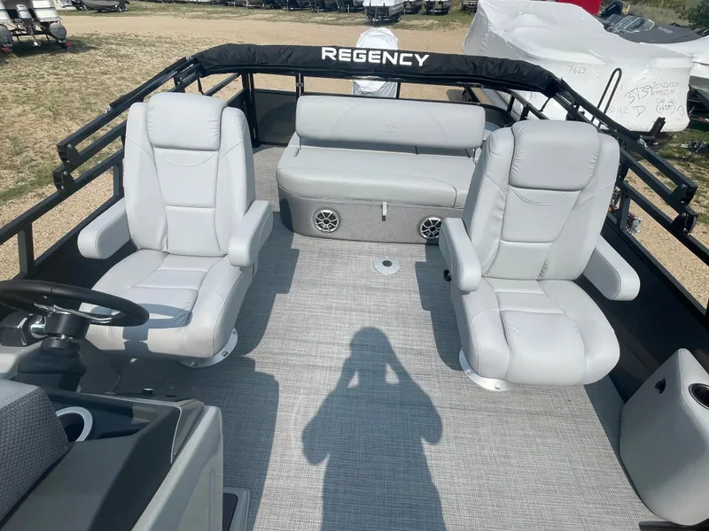 Slide: The Image of 2024 Regency 250 DL3 pontoon boat interior with plush seating and modern design. - 6