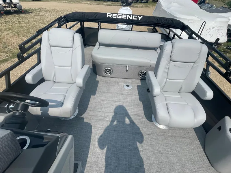 Slide: The Image of 2024 Regency 250 DL3 pontoon boat interior with plush seating and modern design. - 7