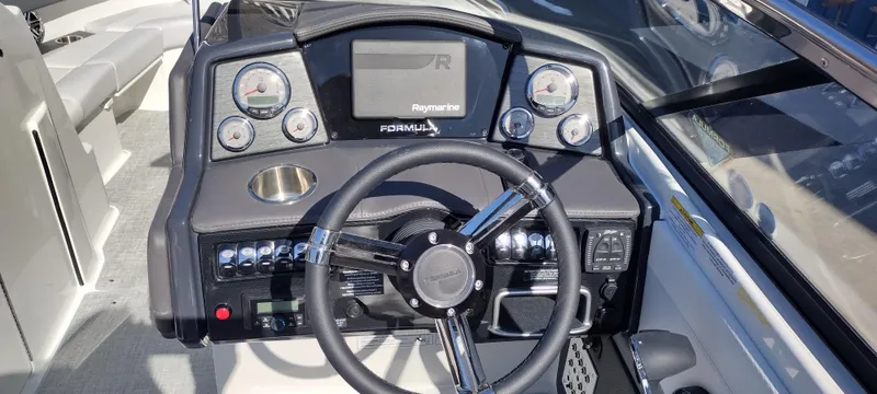 Slide: The Image of 2024 Formula 240 BR boat dashboard with steering wheel and control panel. - 16