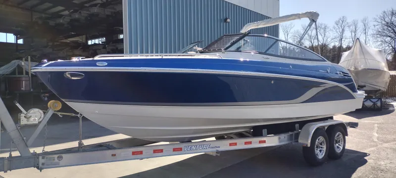 Slide: The Image of 2024 Formula 240 BR boat on a trailer outside a storage facility. - 2