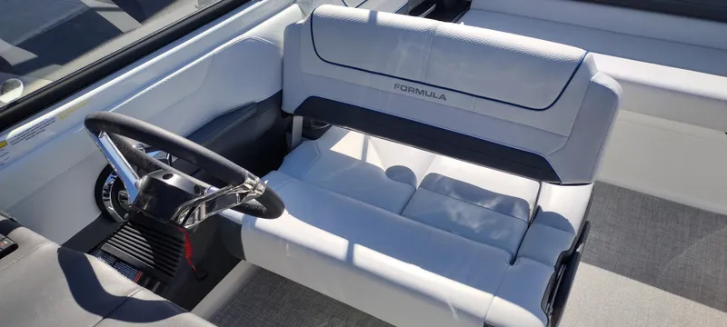 Slide: The Image of 2024 Formula 240 BR boat interior with steering wheel and seating. - 20