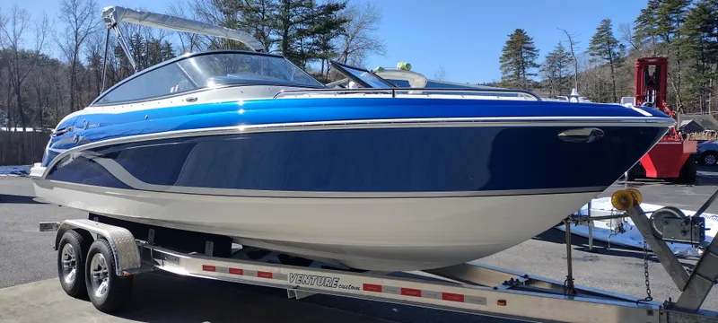 Slide: The Image of 2024 Formula 240 BR boat on a trailer, blue and white exterior. - 4
