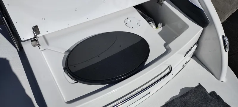 Slide: The Image of 2024 Formula 240 BR boat storage compartment with open lid. - 41