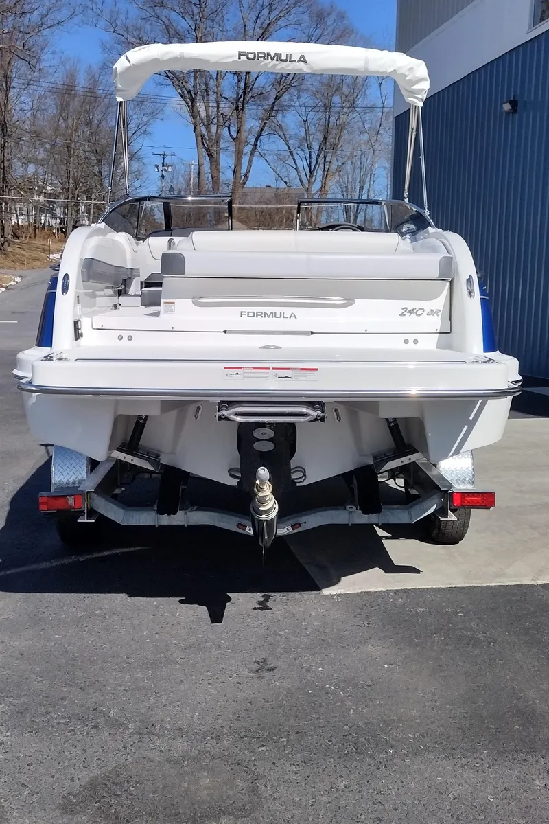 Slide: The Image of 2024 Formula 240 BR boat, rear view, parked outdoors. - 43