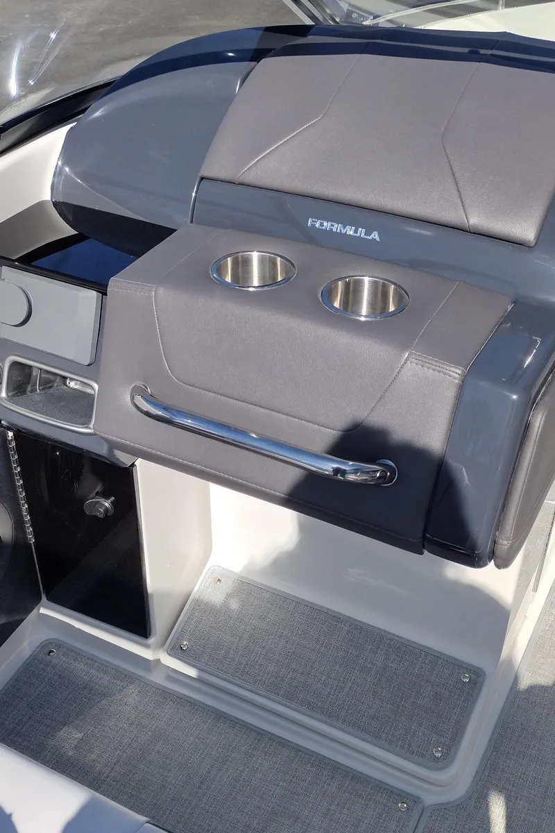 Slide: The Image of 2024 Formula 240 BR boat dashboard with cup holders and storage compartments. - 47