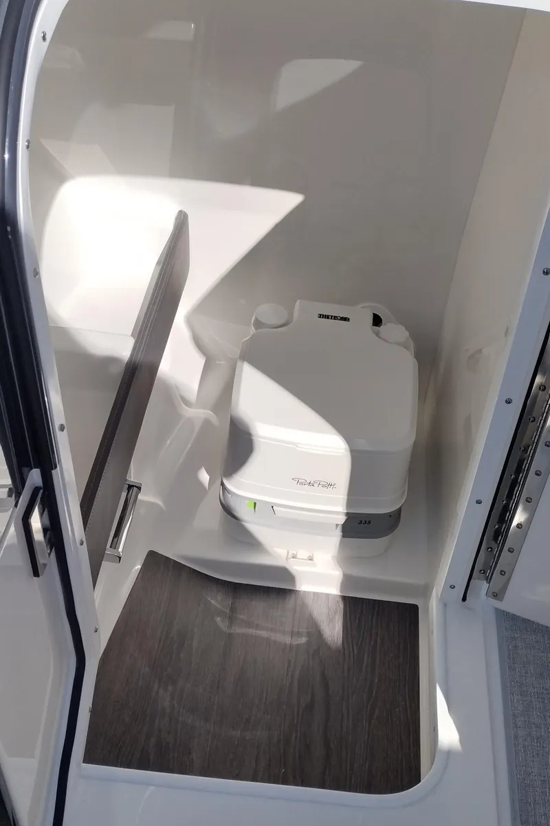 Slide: The Image of 2024 Formula 240 BR boat interior with portable toilet. - 49