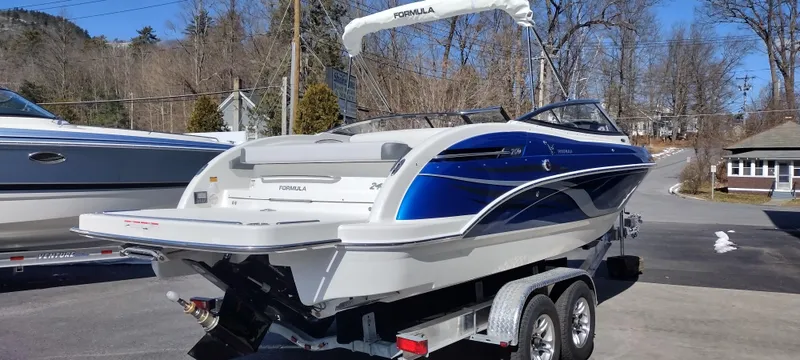 Slide: The Image of 2024 Formula 240 BR boat on trailer, blue and white, rear view. - 7