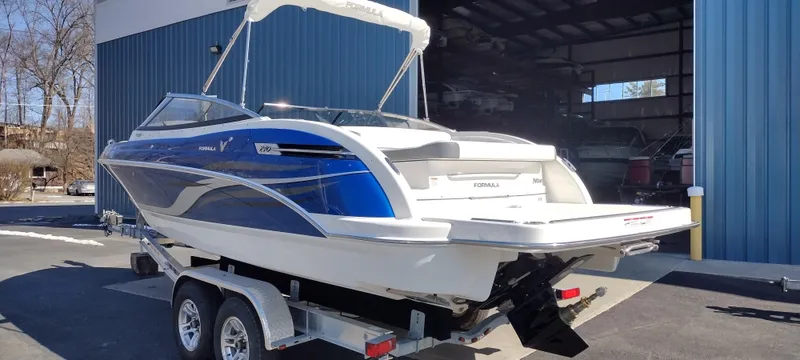 Slide: The Image of 2024 Formula 240 BR boat on a trailer outside a blue building. - 8