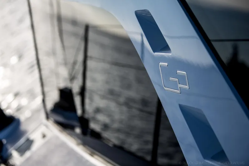 Slide: The Image of Gunboat 60 yacht, 2015 model, featuring sleek design and reflective windows. - 10