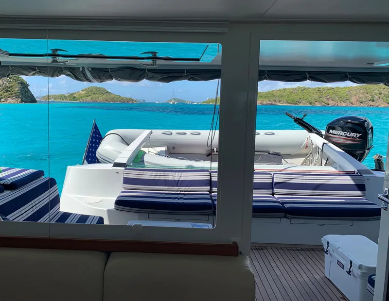 Slide: The Image of Gunboat 60 yacht interior with ocean view, featuring striped seating and Mercury outboard motor. - 12