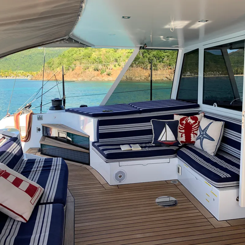 Slide: The Image of Luxurious 2015 Gunboat 60 yacht deck with striped seating and nautical-themed pillows. - 14