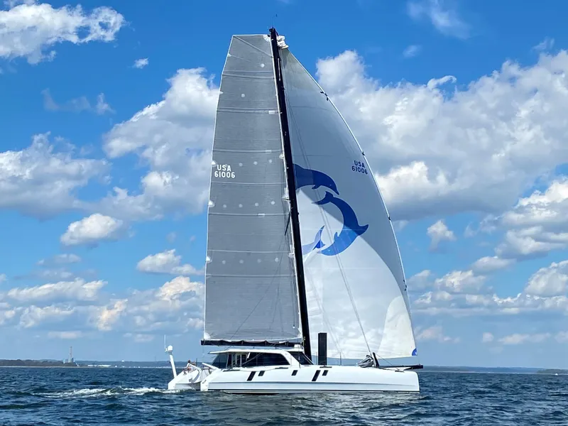 Slide: The Image of Gunboat 60 sailing on open water under a clear blue sky, 2015 model. - 2