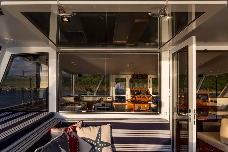 Slide: The Image of Luxurious interior of 2015 Gunboat 60 yacht with striped seating and scenic views. - 26