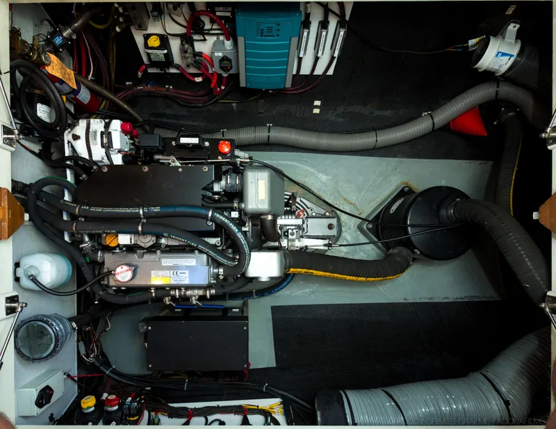 Slide: The Image of Engine room of a 2015 Gunboat 60, showcasing complex machinery and wiring. - 31