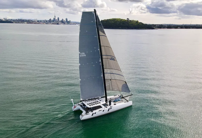 Slide: The Image of Gunboat 60 sailing catamaran, 2015 model, cruising on calm waters near a city skyline. - 5