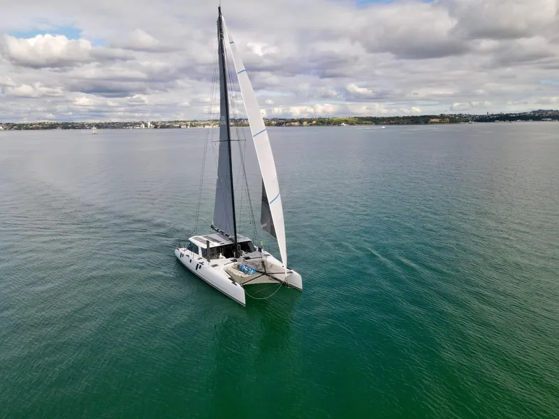 Slide: The Image of 2015 Gunboat 60 catamaran sailing on calm waters under a cloudy sky. - 6