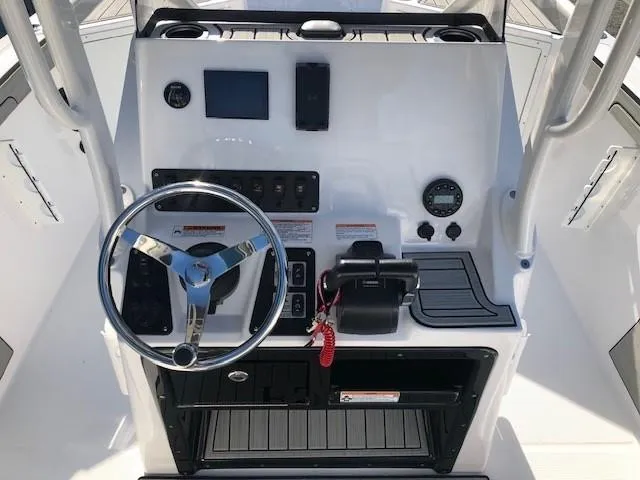 Slide: The Image of 2024 Yamaha Boats 220 FSH Sport dashboard with steering wheel and controls. - 10