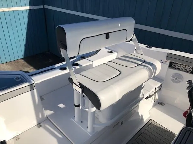 Slide: The Image of 2024 Yamaha Boats 220 FSH Sport interior with white seating and modern design. - 12