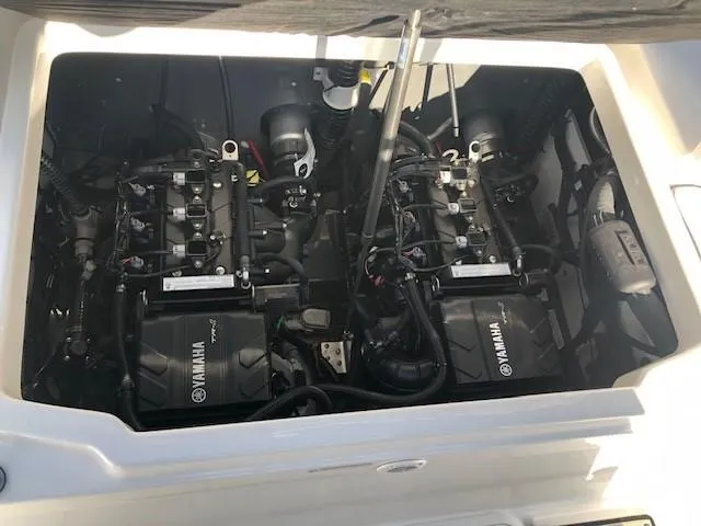 Slide: The Image of 2024 Yamaha Boats 220 FSH Sport engine compartment with dual Yamaha engines. - 17