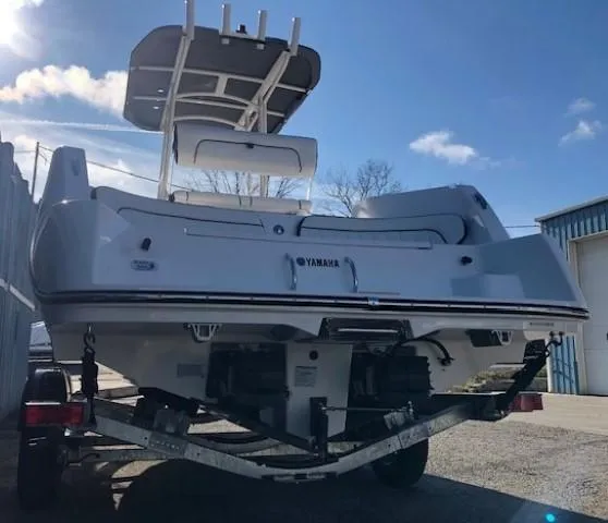 Slide: The Image of 2024 Yamaha Boats 220 FSH Sport on trailer, rear view, sunny day. - 3