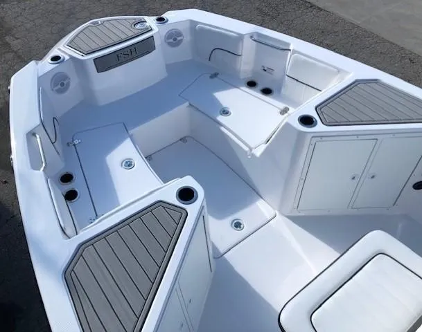 Slide: The Image of 2024 Yamaha Boats 220 FSH Sport interior, featuring spacious seating and storage compartments. - 6